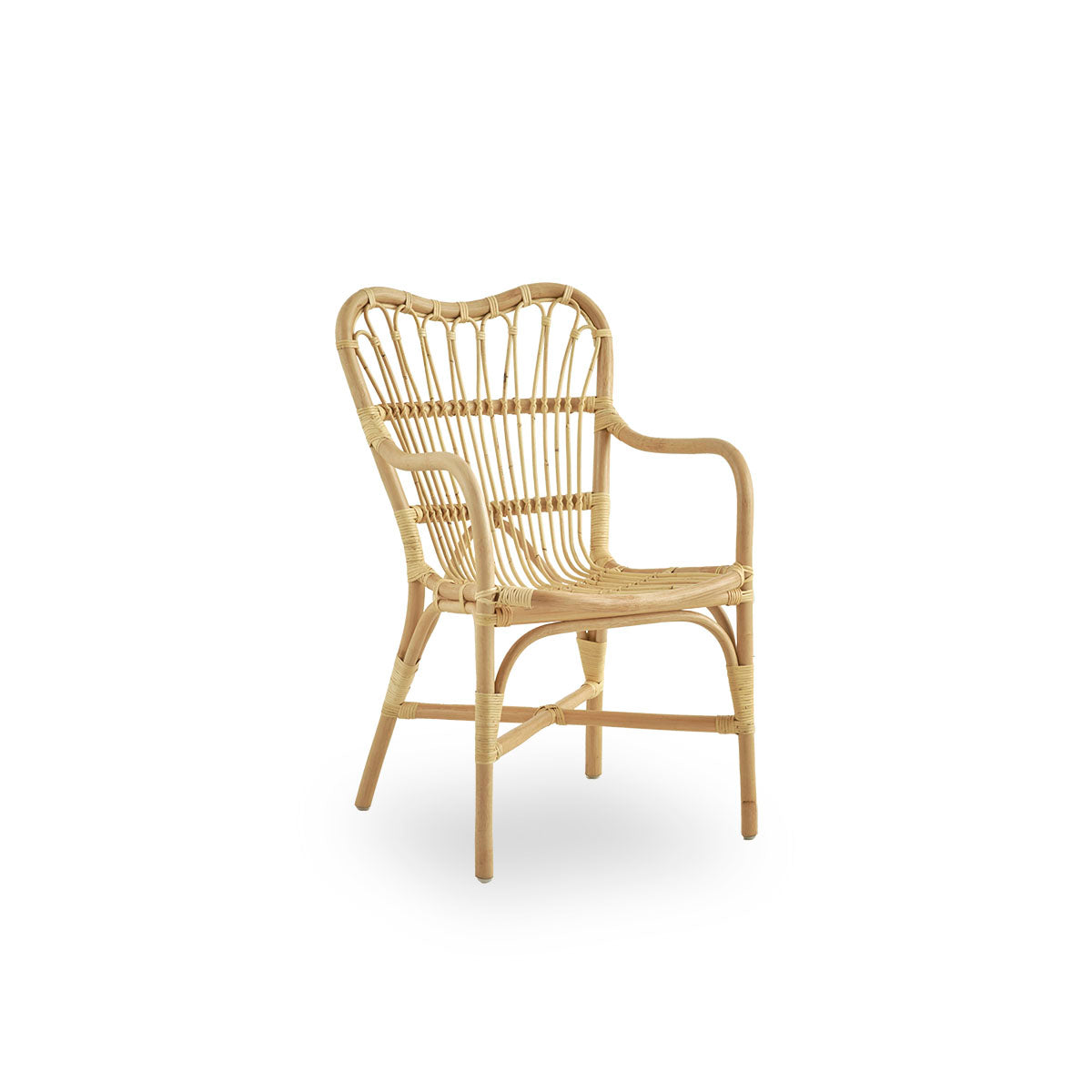 Side view of Margret dining chair with high wide backrest and curved armrests. Handcrafted from high-quality Indonesian rattan.