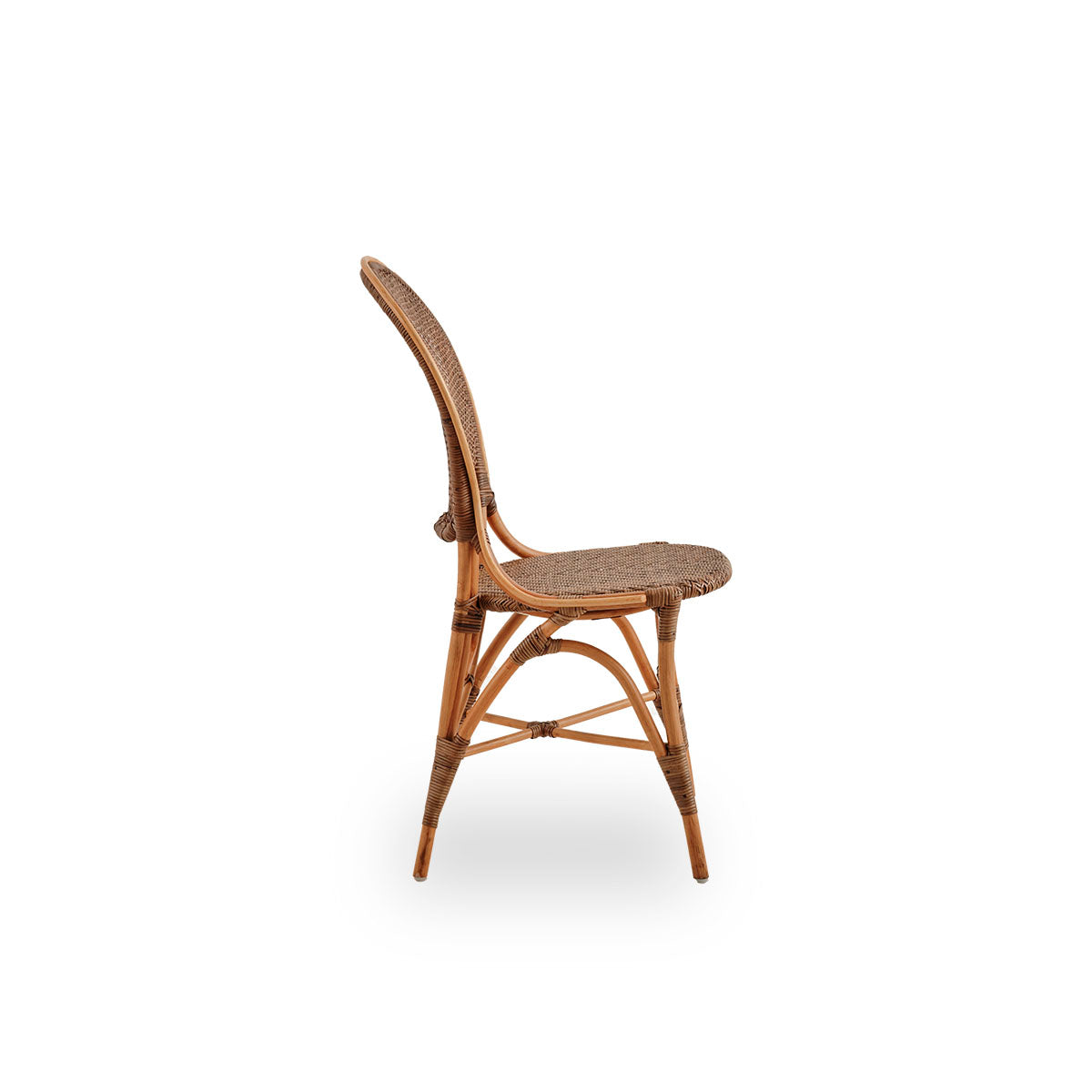 Plain side view of Rossini dining chair in Cherry color. Elegant wicker chair with round backrest in simple design. Handcrafted from high quality rattan.