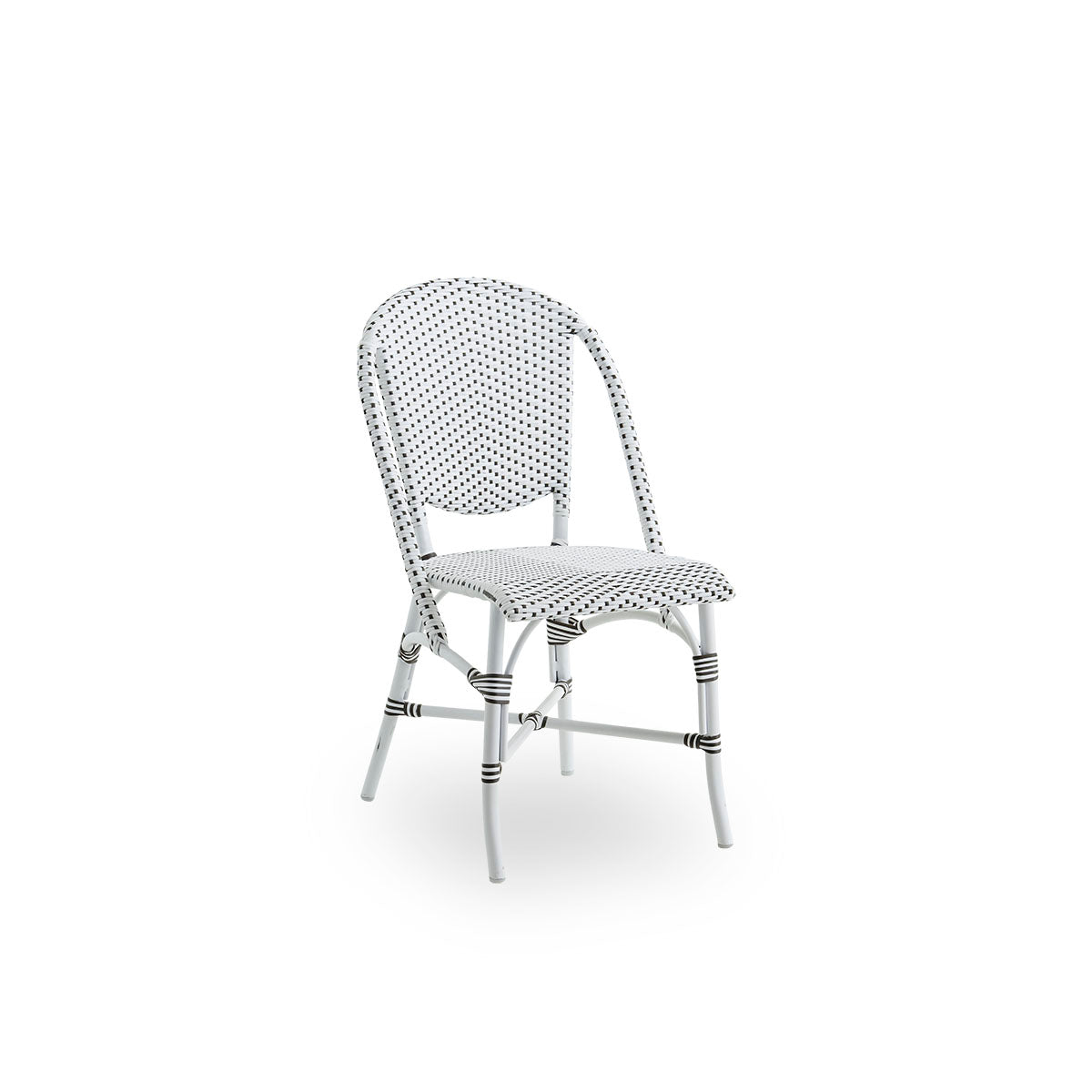 Side view of Sofie outdoor dining chair inspired by French café style. Aluminium frame in white color with fully woven seat- and backrest handcrafted in ArtFibre in white with brown dots pattern. Stackable outdoor bistro chair.
