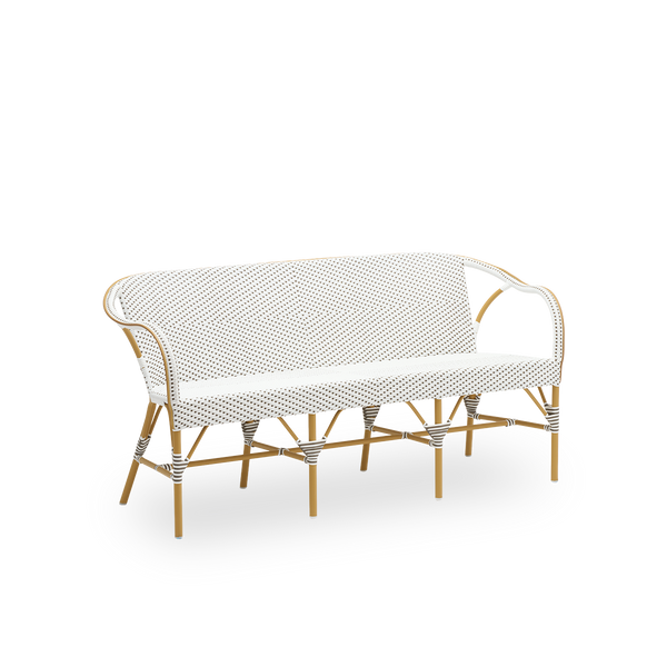 Seitenansicht der Madeleine Außenbank, mit mandelfarbenem Gestell und weißem ArtFibre mit Cappuccino-Punkten. Teil der Alu-Affäire-Kollektion, inspiriert von Sika-Designs 1950er-Entwürfen und Pariser Bistros. Ganzjährig draußen.