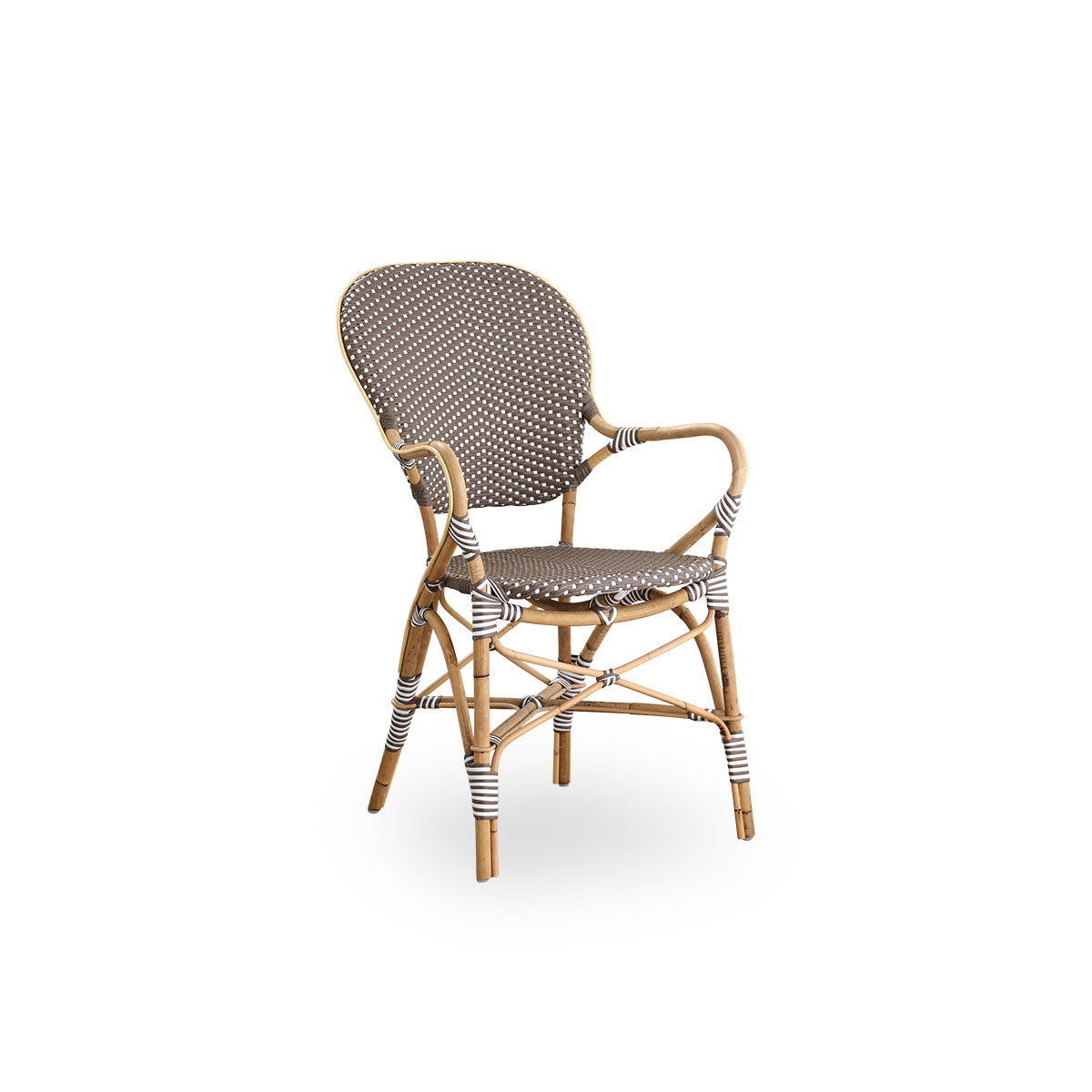 Side view of Isabell dining chair with armrest. Rattan frame with seat and backrest made in brown ArtFibre with white dots. Inspired by 1950s bistro design.