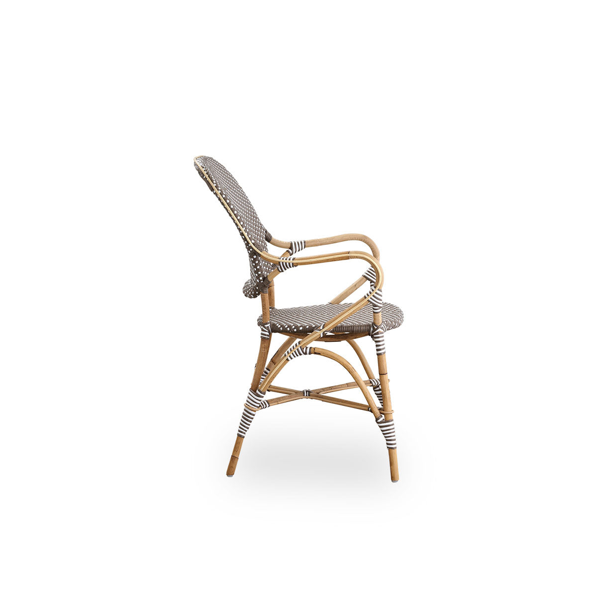 Plain side view of Isabell dining chair with armrest. Rattan frame with seat and backrest made in brown ArtFibre with white dots. Inspired by 1950s bistro design.