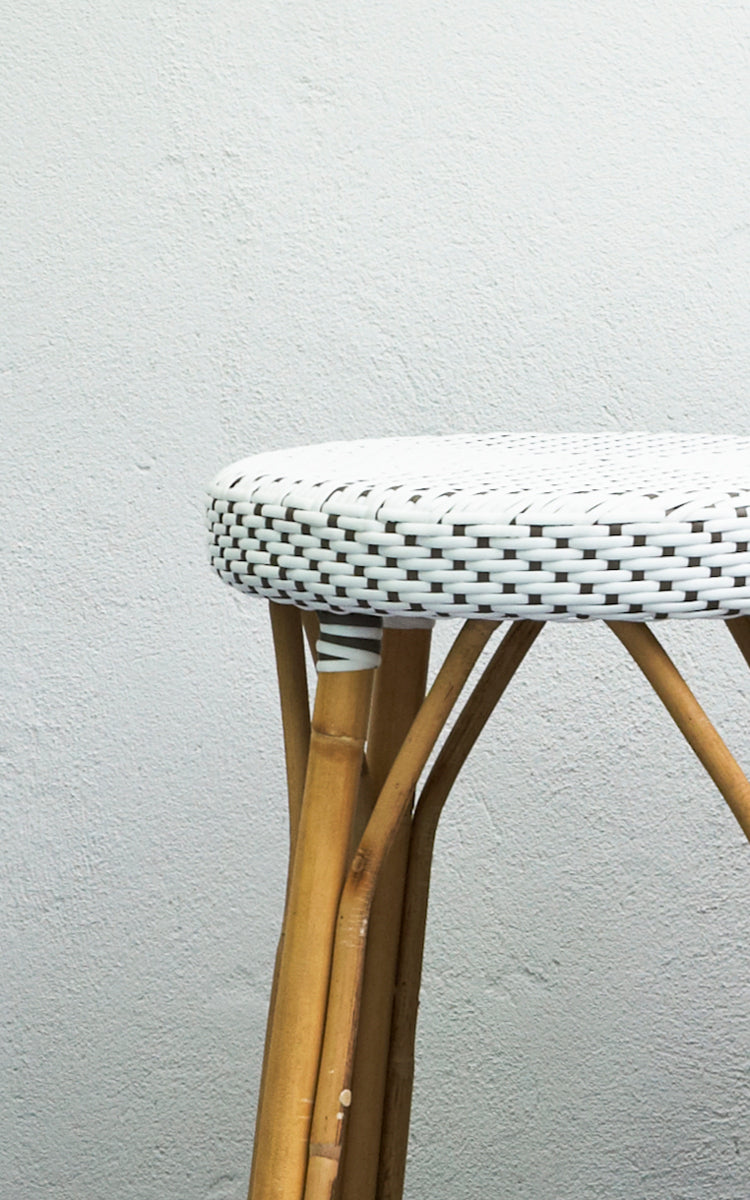 Dies ist ein Nahaufnahmebild von Simone Barstuhl in white w cappuccino dot ArtFibre Skin on Rattan frame. Vor einer weißen Wand gezeigt.